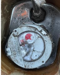 Broken water meter used for leak detection testing showing abnormal readings and corrosion.